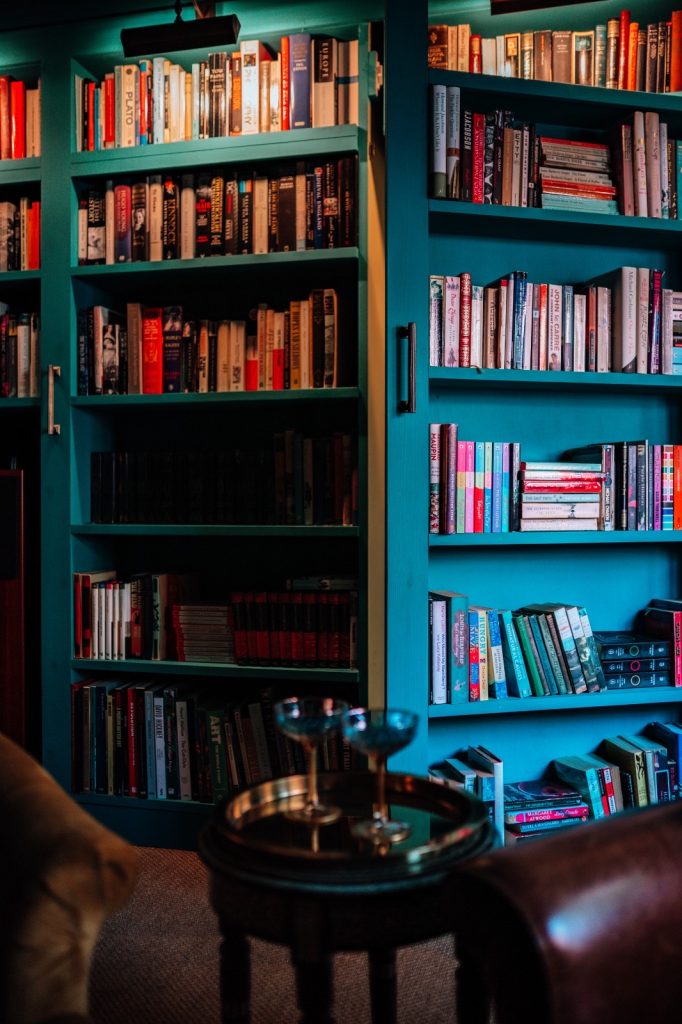 Book case with hidden door in a warm and sophisticated snug