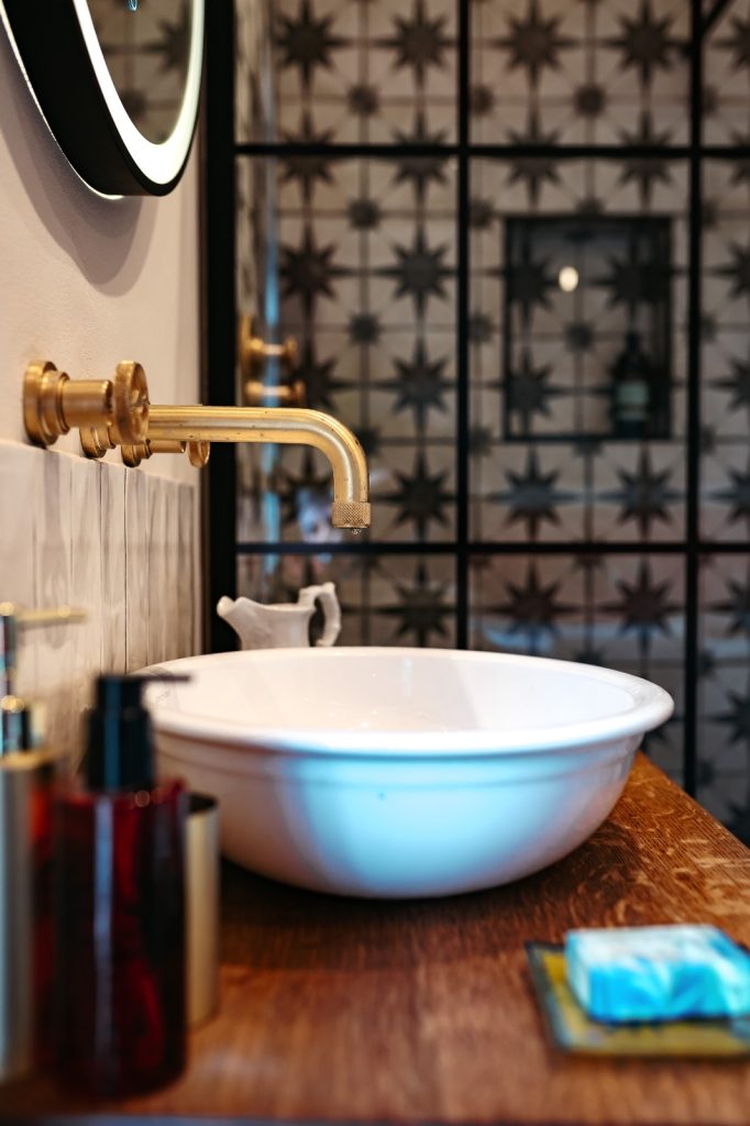 Interior Design of an elegant and traditional bathroom gold tap and sink