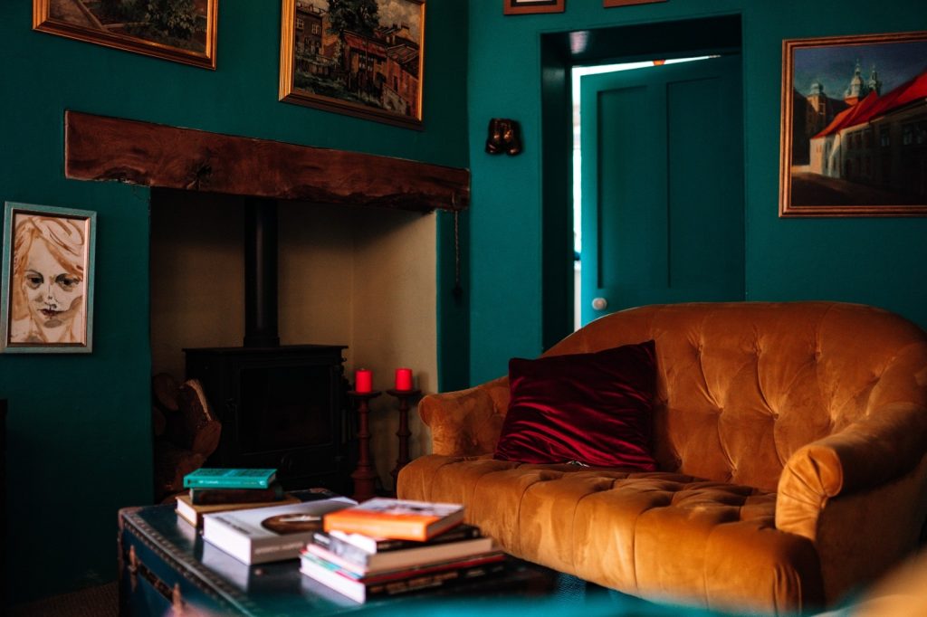 Warm and sophisticated snug focus on fire place and sofas